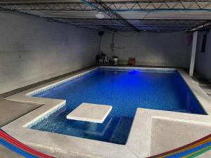 a large swimming pool with blue water in a room at Evolution Home in Astoria