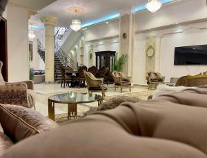 a large living room with couches and a tv at Trio Villa with coverable private pool in compound near Mall of Egypt in Sheikh Zayed