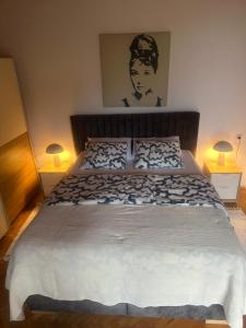 a bedroom with a large bed with two lamps at Apartment Marino in Senj