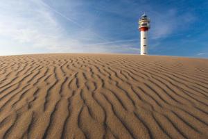 a lighthouse sitting on top of a sand dune at Casita Flamingo in Deltebre +7 photos