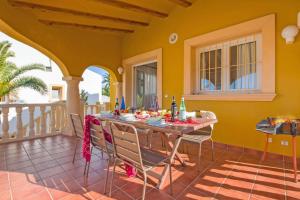 a dining room with a table and chairs on a balcony at Villa Verde by Villa Plus in Balcon del Mar