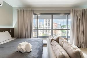 a bedroom with a large bed and a large window at Studio NOVO na Vila Mariana! in Sao Paulo +48 photos