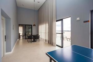 a dining room and living room with a blue table at Studio Completo Perto de Tudo! - Destino CWB 710 in Curitiba