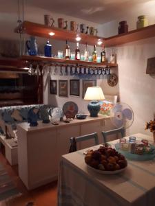 a kitchen with a table with a bowl of fruit on it at Luxury Sea View Apartment 100 mt Mare in Costa Paradiso