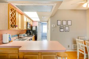 a kitchen with a sink and a counter top at Quaint Wildwood Condo about Walk to Beach! in Wildwood