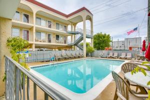 a pool on a balcony with chairs and tables at Quaint Wildwood Condo about Walk to Beach! in Wildwood