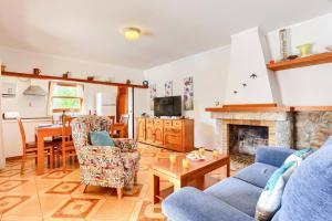 a living room with a couch and a fireplace at Villa Andreu by Villa Plus in El Port