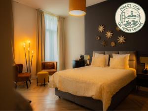 a bedroom with a bed and a sign on the wall at Hotel Grand Place in Mons