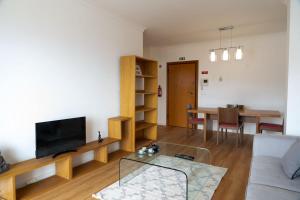 a living room with a couch and a table at Garajau Sea View in Caniço