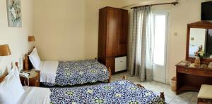 Postel nebo postele na pokoji v ubytování Hotel Anagennisis