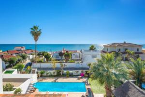 an aerial view of a villa with a swimming pool and the ocean at Villa La Cala Playa by Villa Plus in La Cala de Mijas