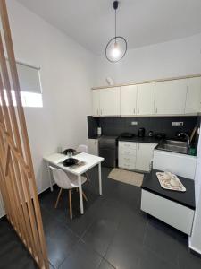 une cuisine avec une table blanche et un comptoir blanc dans l'établissement Center Apartment Heraklion, à Héraklion