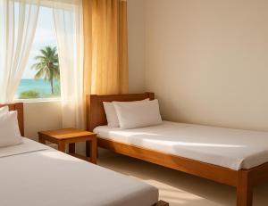 a bedroom with two beds and a window with a palm tree at Uroa Ocean Escape - Stylish 2-Bedroom Apartment with Terrace & Sea Views in Uroa
