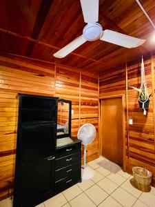 a kitchen with a ceiling fan and a black refrigerator at Wasi la Punta 2 Starlink 2min walk to the beach in Brisas de Zicatela +35 photos
