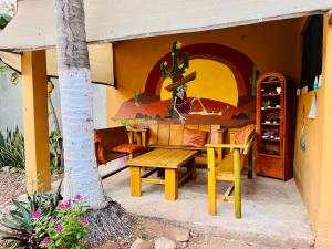 a table and bench outside of a house at Wasi la Punta 2 Starlink 2min walk to the beach in Brisas de Zicatela