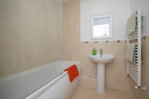 a bathroom with a bath tub and a sink at 1-Bed Apartment in Bournemouth centre in Bournemouth +11 photos