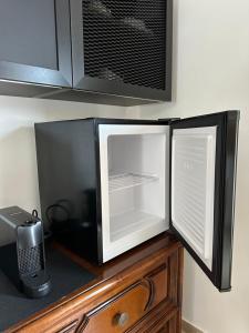a microwave sitting on top of a wooden cabinet at Pink House in Camporosso