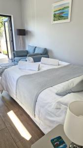 a bedroom with two beds and a couch at Fyrish View in Dingwall