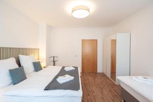 En eller flere senge i et værelse på Benville Freital - 2 Schlafzimmer - Wohnküche - WLAN