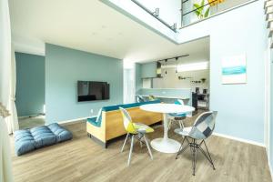 a living room with a table and chairs at RD House in Katsuyama