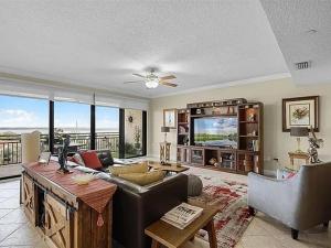 a living room with a couch and a television at Spacious Lakefront Condo in Kissimmee in Kissimmee