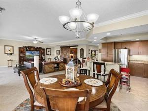 a kitchen and living room with a table and chairs at Spacious Lakefront Condo in Kissimmee in Kissimmee