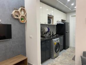 a kitchen with a washer and dryer in a room at Luxury serviced apartments in Hurghada