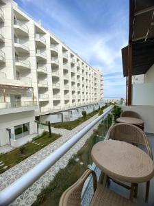 a balcony with tables and chairs and a building at Luxury serviced apartments in Hurghada
