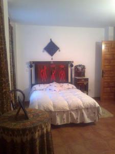 Un dormitorio con una cama con cuatro hombres rojos. en Fuerte de San Mauricio, en Palazuelo de Vedija 37 fotos más