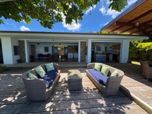 two chairs and a table on a patio at Villa Miti Vai by ENJOY VILLAS in Iumaru +39 photos