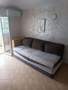 a bed in the corner of a room at Zevs Apartmani 2 in Igalo