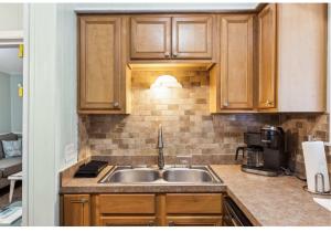 a kitchen with wooden cabinets and a sink at Relaxing Condo for 6 in Popular Hilton Head Resort in Hilton Head Island