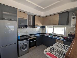 a kitchen with a refrigerator and a dishwasher at Kelibia Beach appartments in Kelibia