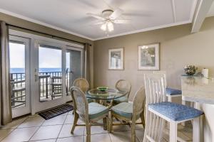a dining room with a glass table and chairs at Top floor Oceanfront condo that has spectacular ocean views and sunrises. This condo sleeps 6. in Fernandina Beach