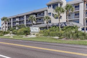a building with a sign in front of a street at 2 Bed/2 Bath Oceanfront condo sleeps 6. Oceanfront deck and pool. in Fernandina Beach