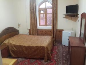 Gulta vai gultas numurā naktsmītnē Islambek Hotel & Travel