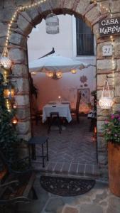 an outdoor patio with a table and an archway at Casa Marina, Cilento Appartamento Suite indipendente in Ceraso