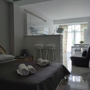 a bedroom with a bed with towels on it at Aggelikas apartments 2 in Paleokastritsa