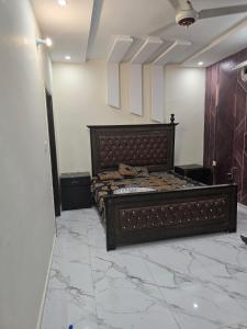 a large bed in a room with a marble floor at Cozy 1 Bed Studio on Canal Rd in Dargai