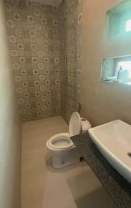 a bathroom with a white toilet and a sink at Cozy 1 Bed Studio on Canal Rd in Dargai
