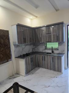 a kitchen with wooden cabinets in a room at Cozy 1 Bed Studio on Canal Rd in Dargai
