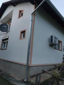 a white building with a sign on the side of it at Apartmani Nurka in Orašac