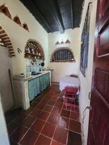 a kitchen with a counter and a table in it at Le bon coin "El Buen Rincon" in Taganga
