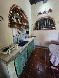 a kitchen with a sink and a counter top at Le bon coin "El Buen Rincon" in Taganga +11 photos