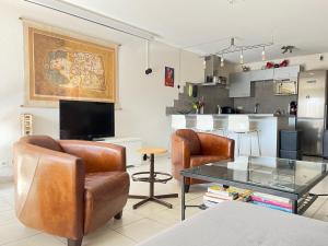 - un salon avec des fauteuils en cuir et une table en verre dans l'établissement Annecy Genève & Rochexpo, à Bonneville