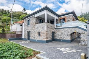 a house with a stone facade at Villa Pomar, By OP in Senhora do Rosário