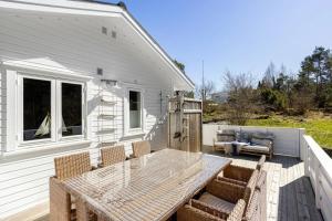 a patio with a table and chairs on a deck at Fjordlykke in Porsgrunn