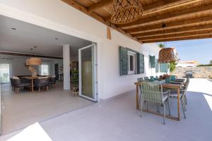 a dining room and living room with a table and chairs at Villa MI LOLA in Torrevieja
