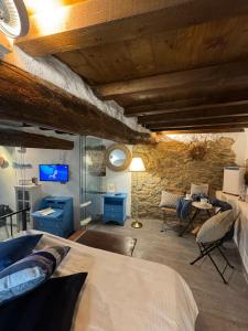 a bedroom with a bed and a stone wall at Rio Alba blu loft - holiday house 5 terre Riomaggiore in Riomaggiore