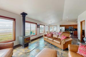 un soggiorno con divano e camino di Westport Waves Beach House a Westport
